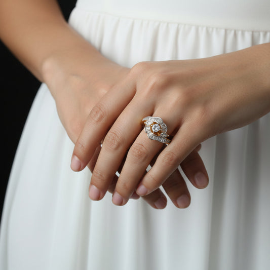 Gold and diamond ring held by a hand with a white background