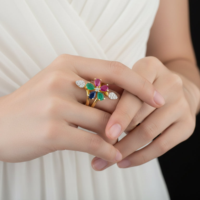 Multicolored gemstone ring on a black mannequin hand with 'SAHELI' branding.