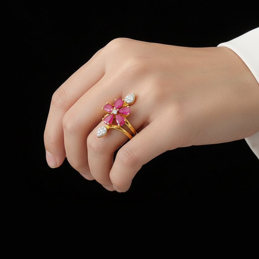 Gold ring with pink gemstones on a black mannequin hand, branded 'Saheli'.