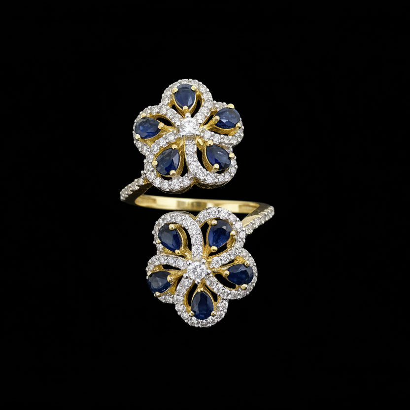 Gold and blue gemstone ring on a dark background with 'SAHELI' branding.