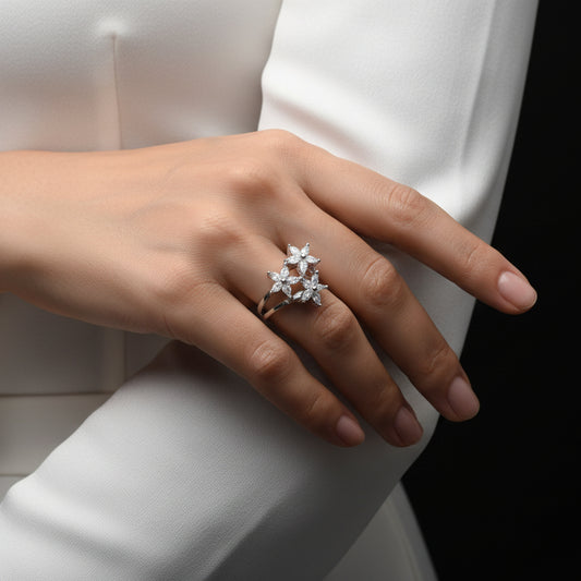 Silver ring with diamonds on a gray background, featuring the brand 'Saheli'.