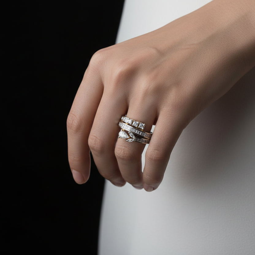 Gold ring with diamonds on a black mannequin hand, branded 'SAHELI'.