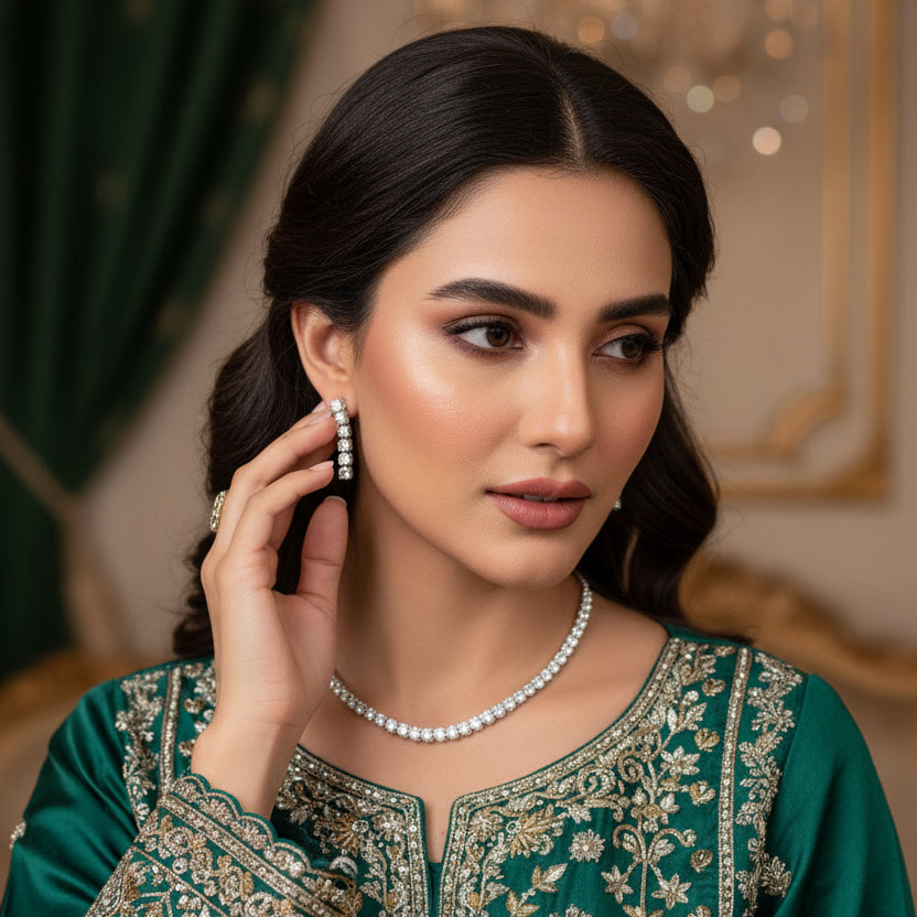 Diamond necklace and earrings set on a gray background
