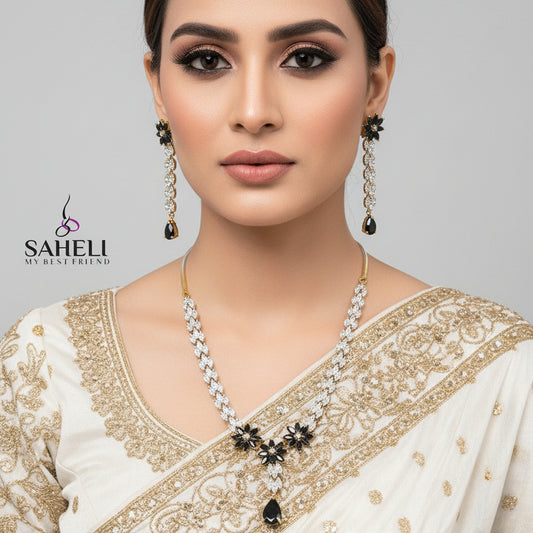 Jewelry set with necklace and earrings on a gray background, featuring the brand 'SAHELI'.