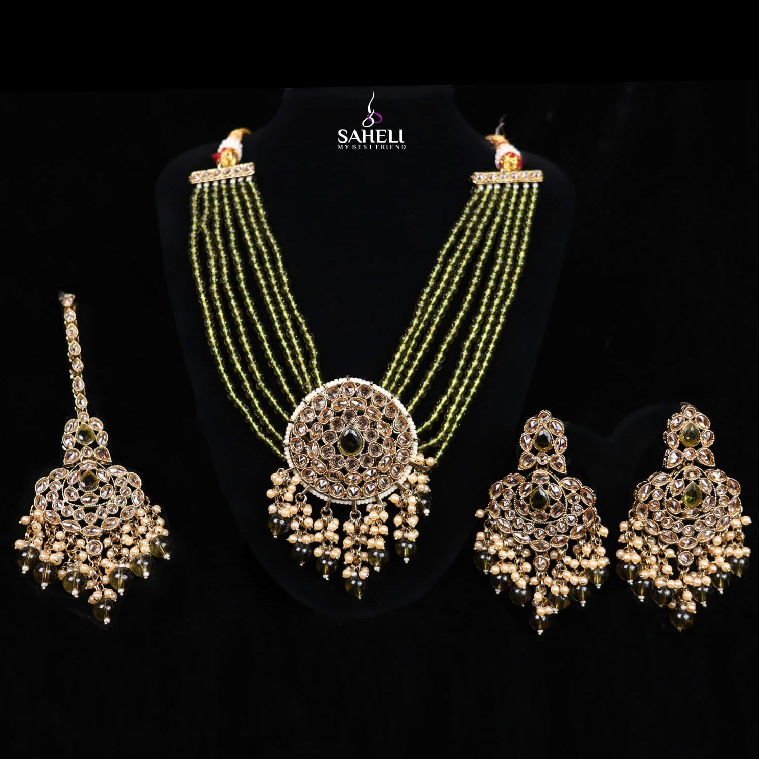 Jewelry set with necklace, earrings, and choker on a black background with 'Saheli' branding.