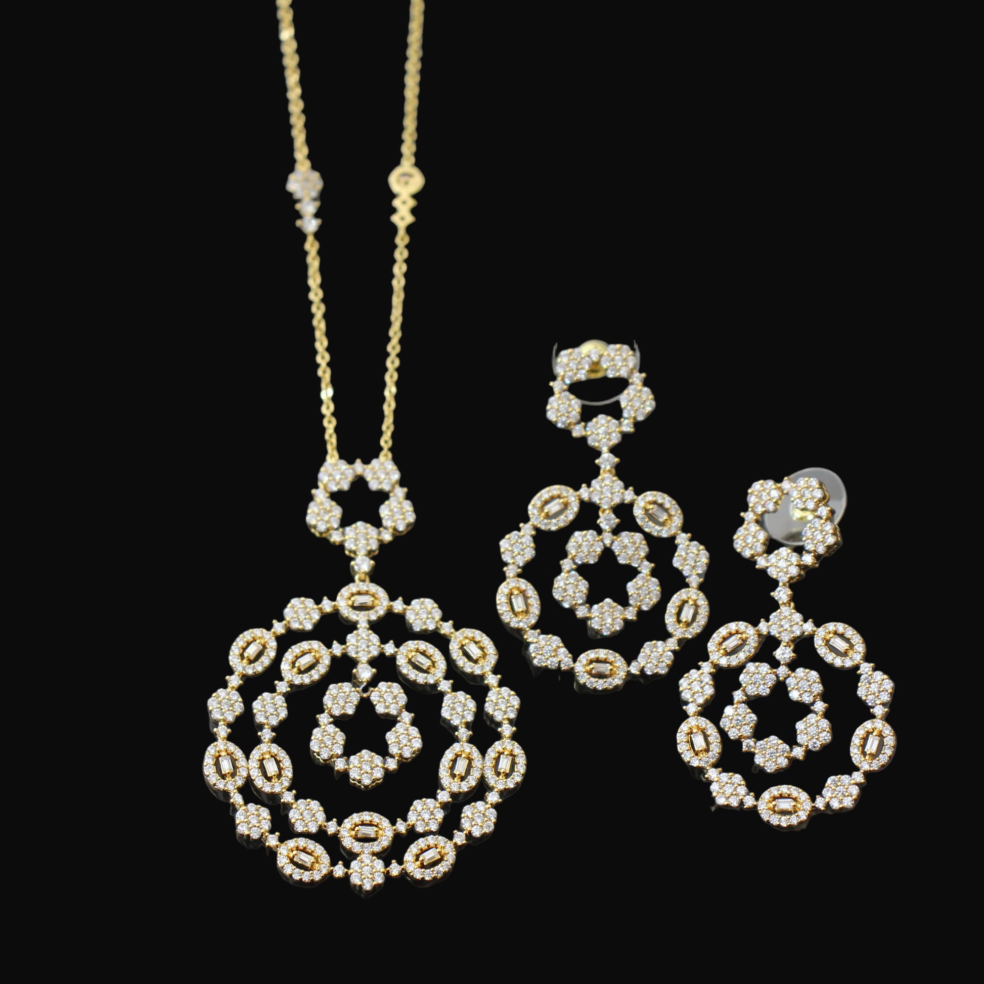 Gold and diamond jewelry set on a dark background