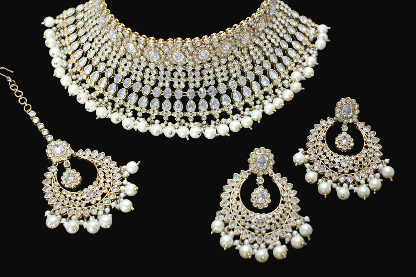 Jewelry set with necklace, earrings, and choker on a dark background