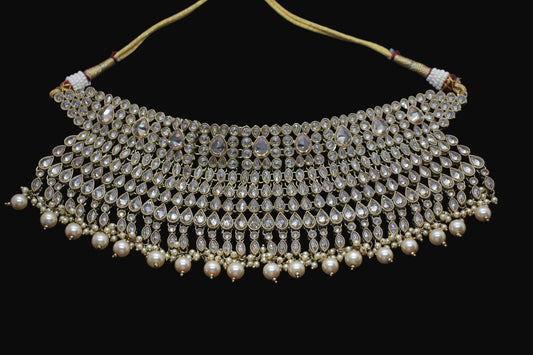 Ornate necklace with pearls and gemstones on a dark background