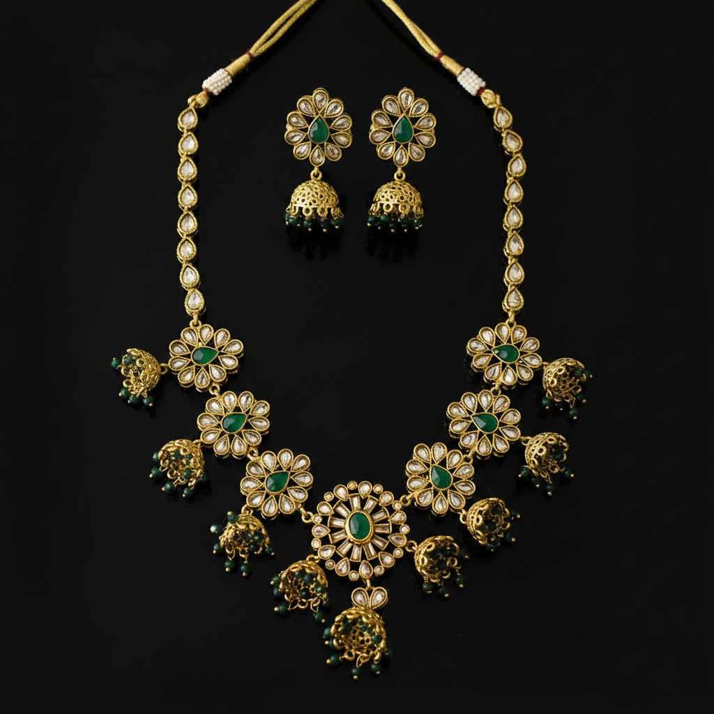 Gold-plated Kundan necklace and matching earrings with green stone accents, displayed on a dark gray background with the SAHELI MY BEST FRIEND logo in the top left corner.