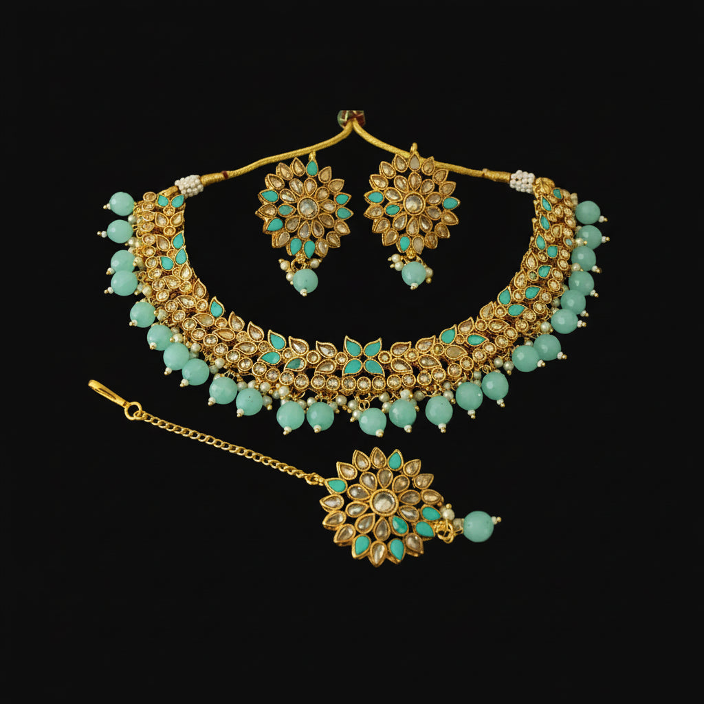Gold and turquoise jewelry set on a dark background