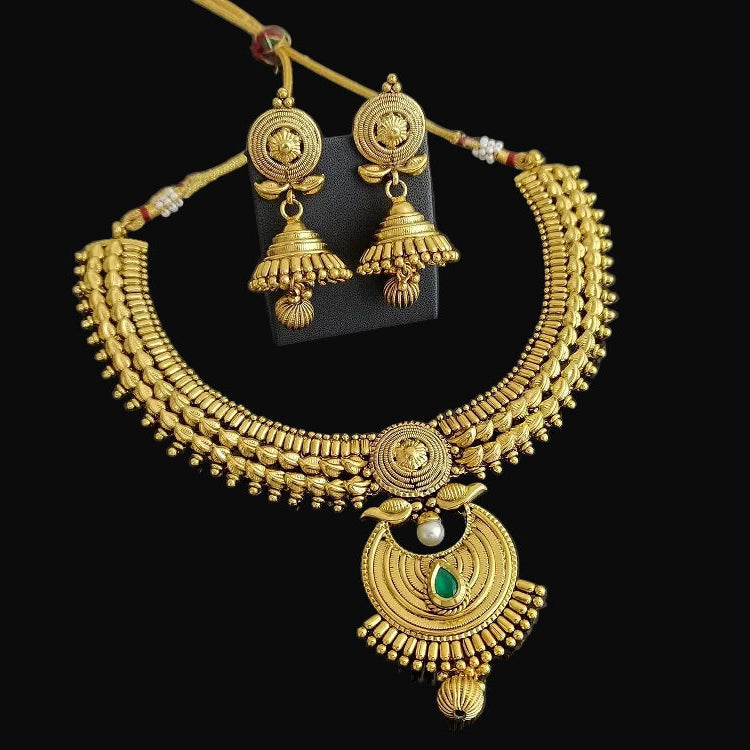 Gold necklace and earrings on a black background with 'SAHELI' branding.