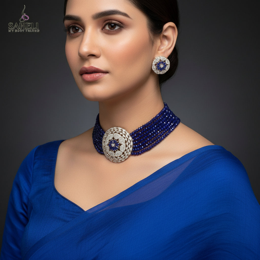 Jewelry set with blue beads and gold accents on a dark background