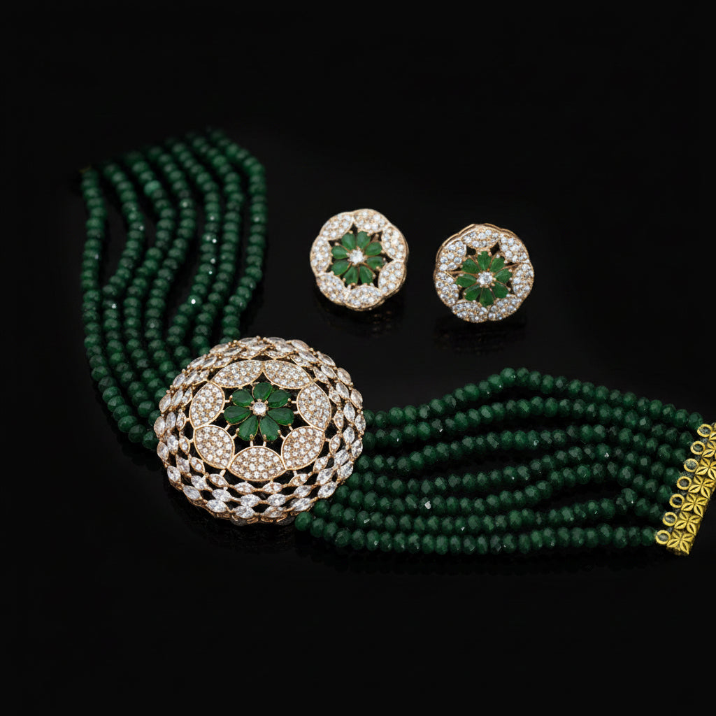 Green beaded necklace with gold and diamond earrings on a dark background