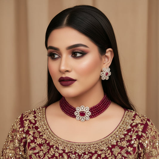 Jewelry set with red beaded necklace and matching earrings on a dark background