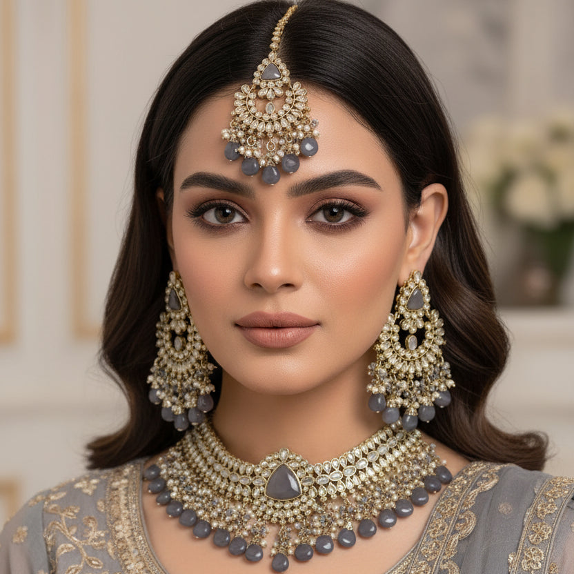 Ornate jewelry set with necklace, earrings, and choker on a reflective surface