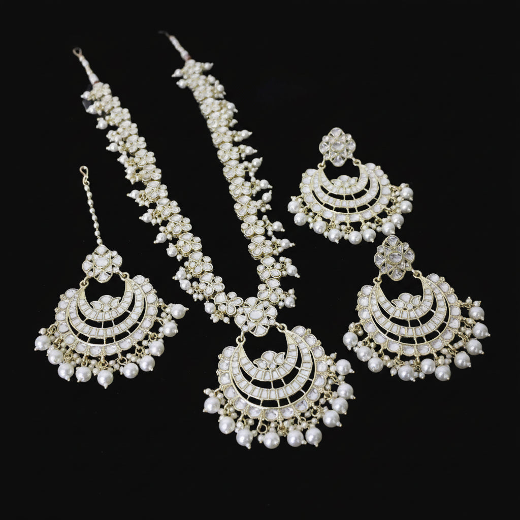 Set of gold and pearl jewelry on a dark background