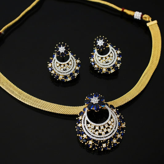 Gold necklace with matching earrings on a dark background