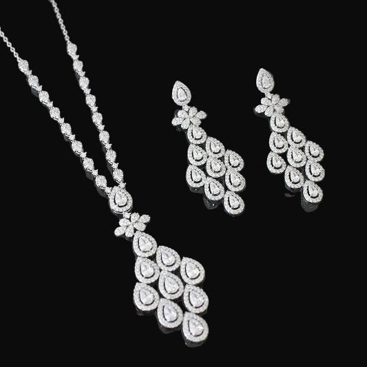 Diamond necklace and earrings set on a dark background