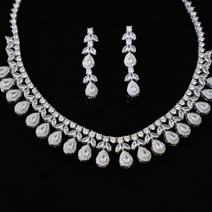 Diamond necklace and earrings set on a black background