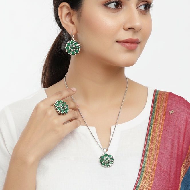 Jewelry set with green floral designs on a gray background
