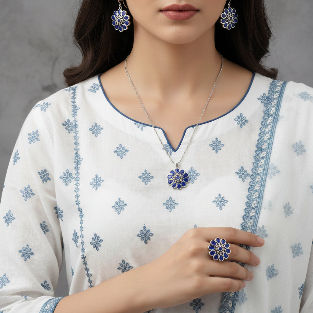 Jewelry set with blue floral designs on a gray background