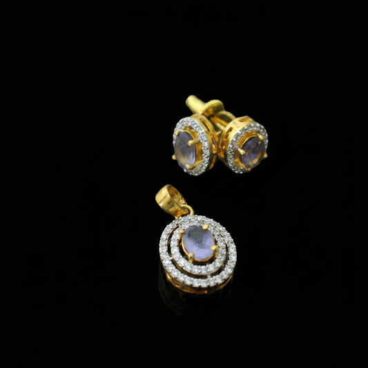 Gold earrings with gemstones on a gray background, featuring the brand 'SAHELL'.