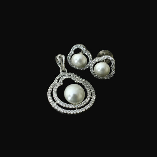 Pearl jewelry set with 'SAHELI' tag on a dark background