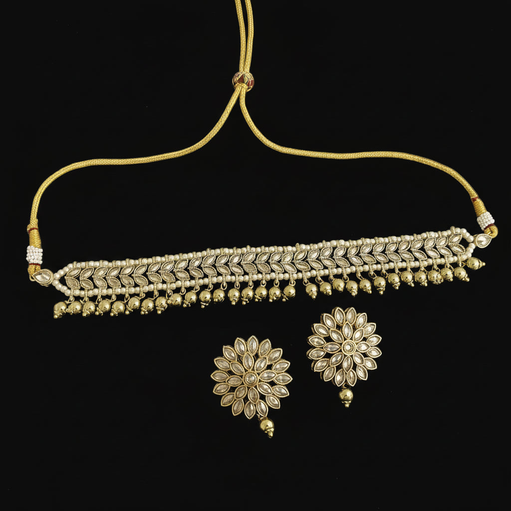 Gold necklace with matching earrings on a dark background